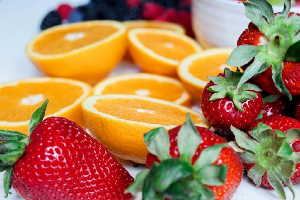 Close-up of sliced oranges and strawberries, showcasing vibrant colors and fresh appeal.