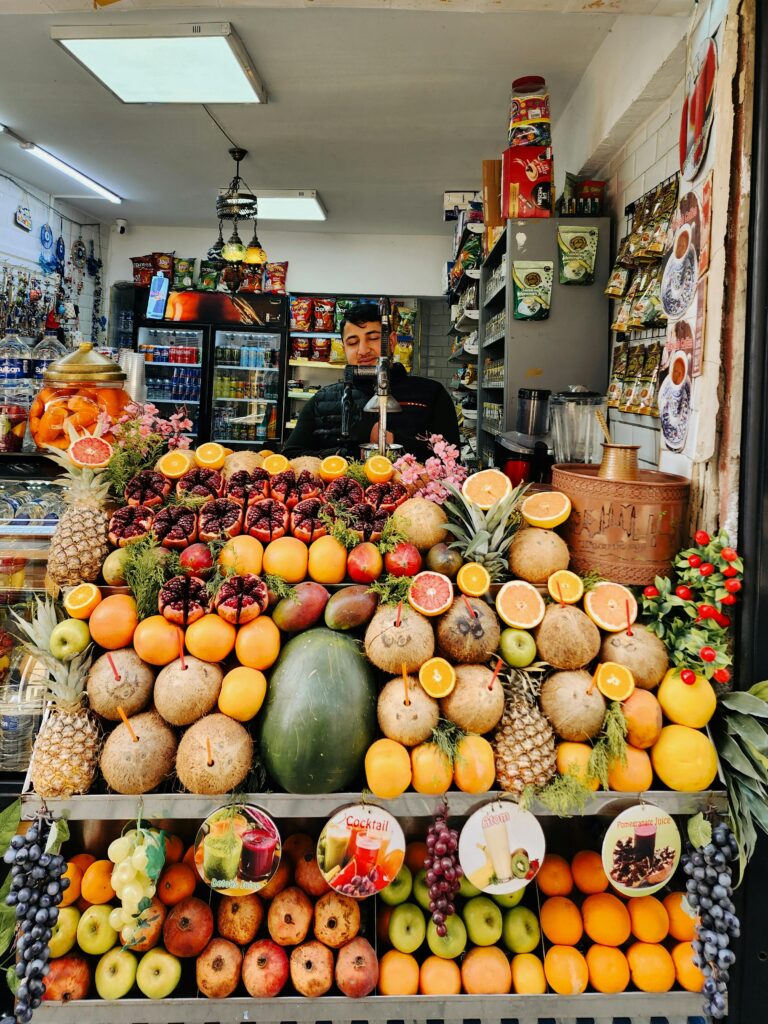 Vibrant display of fresh fruits at a bustling market stand, showcasing exotic produce.