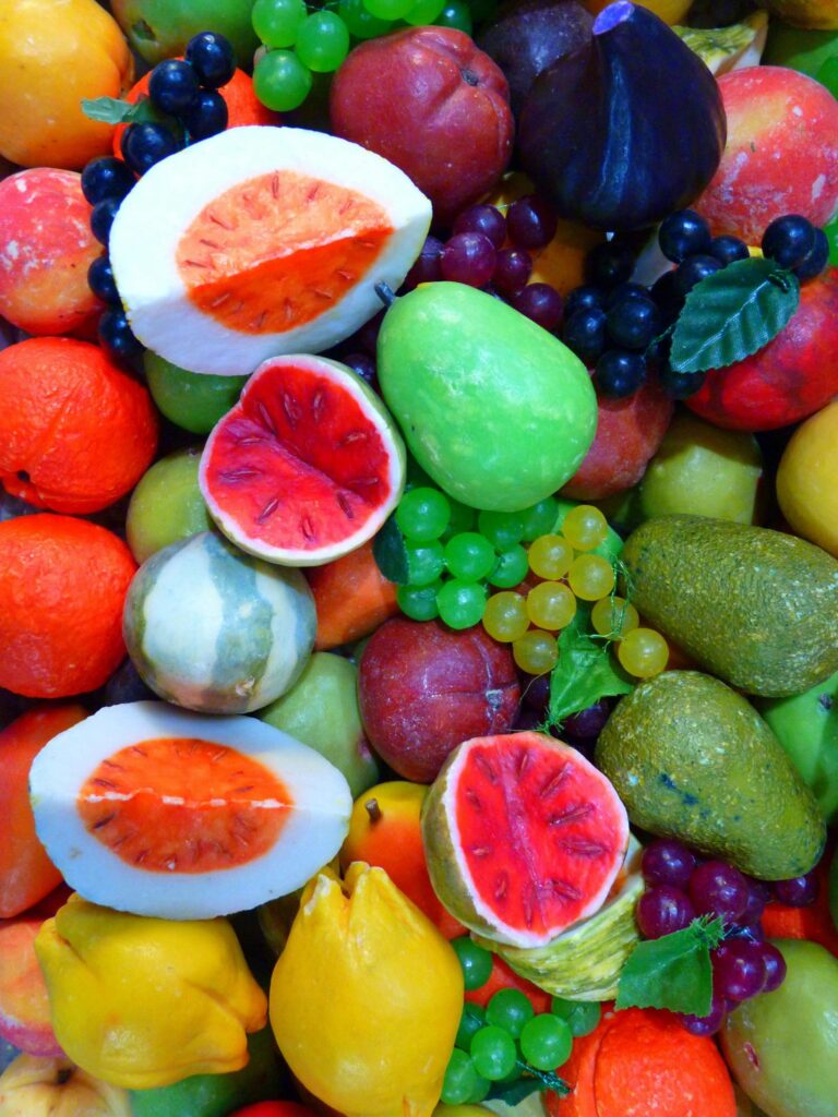 A diverse and vibrant array of colorful fruits, featuring various shapes and textures.